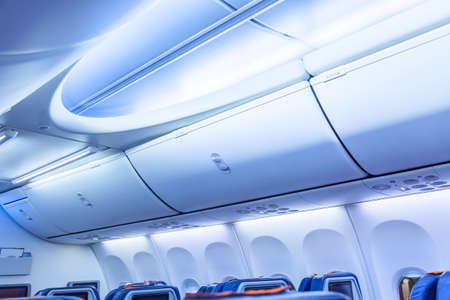 Luggage shelf in an airplane. Aircraft interior. Travel conceptの写真素材