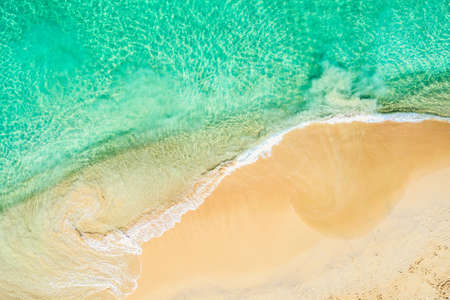 Top view aerial drone photo of ocean seashore with beautiful turquoise water and sea waves....