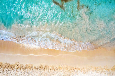 Top view aerial drone photo of ocean seashore with beautiful turquoise water and sea waves....