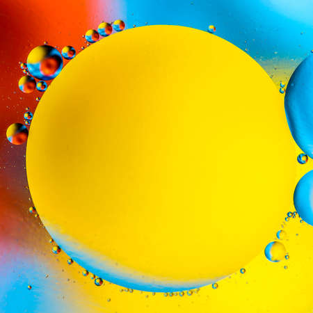 Abstract colorful background with oil on water surface. Oil drops in water abstract psychedelic....