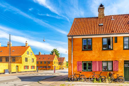 Old yellow houses of Nyboder district with bicycles. Old Medieval district in Copenhagen, Denmark.の写真素材