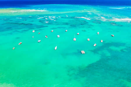 Aerial view of tropical caribbean sea with yachts and boats on blue turquoise ocean. Dominican Republic.の写真素材