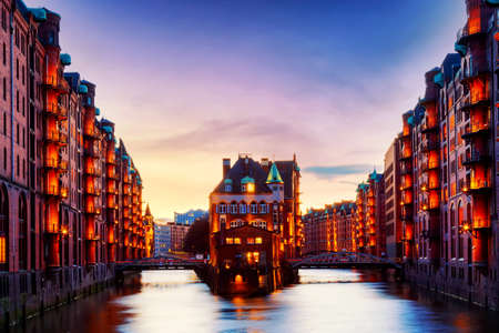 The Warehouse district Speicherstadt during twilight sunset in Hamburg, Germany. Illuminated warehouses in Hafencity quarter in Hamburgの写真素材