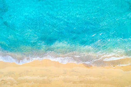 Top view aerial drone photo of ocean seashore with beautiful turquoise water and sea waves....