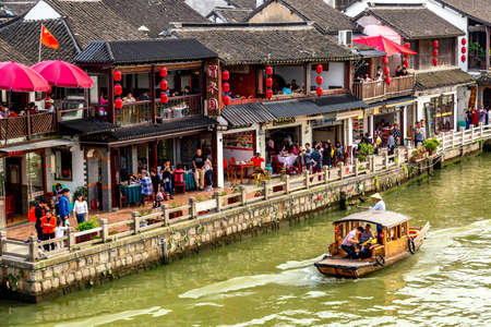 Shanghai, China - May, 2019: China traditional tourist boat on canal of Shanghai Zhujiajiao Old Town in Shanghai, China during sunny day. Chinese Veniceのeditorial素材