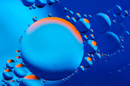 Macro shot of oil bubbles with water on colorful background. Space and universe planets styled psychedelic abstract image.の写真素材
