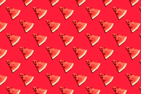 Top view of watermelon slices on red background. Watermelon colorful pattern.