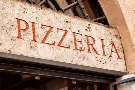 Old retro pizzeria signboard in Rome, Italy.の写真素材