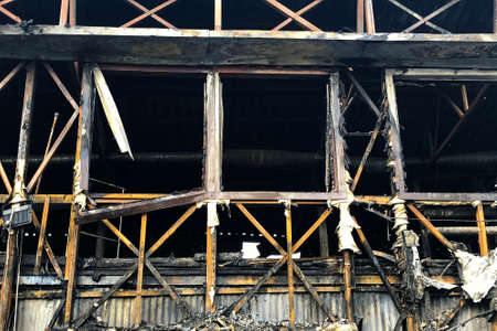 Close up image of burned down wooden house