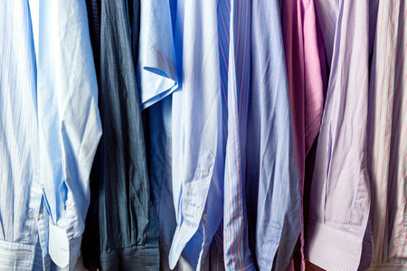 Close up of many shirts on hangers. Shopping concept.の写真素材