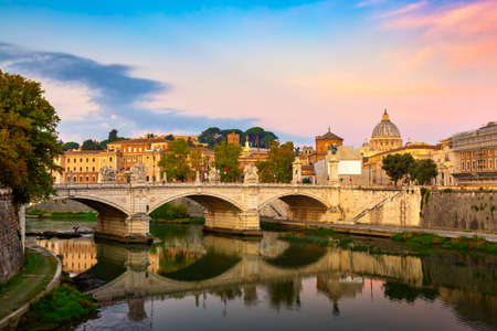 Cityscape view of Rome at colorful sunset with Ponte Sant Angelo and St Peter Cathedral in Vaticanの写真素材