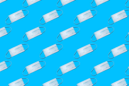 Blue medical protective mask pattern on blue background.の写真素材