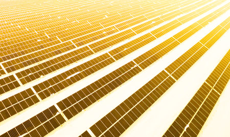 Renewable energy concept. Aerial drone view of solar panels power plant with sunlight in winter.の写真素材