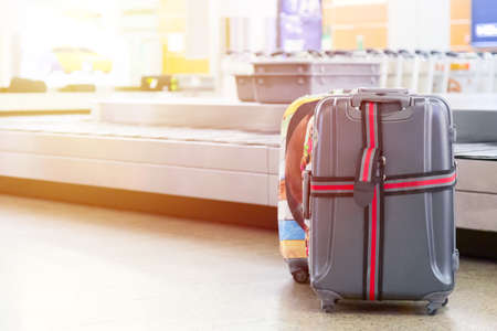 Suitcases near luggage conveyor belt at the airport. Travel concept.の写真素材