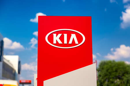 Moscow, Russia - July, 2021: Kia automobile dealership Sign against blue sky. Kia is a South Korean manufacturer of automobiles and commercial vehiclesのeditorial素材