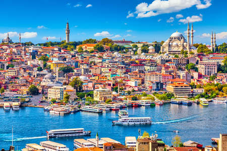 Touristic sightseeing ships in Golden Horn bay of Istanbul and mosque with Sultanahmet district against blue sky and clouds. Istanbul, Turkey during sunny summer dayの写真素材