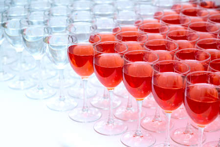 Many glasses with wine in a row. Alcohol backgroundの写真素材