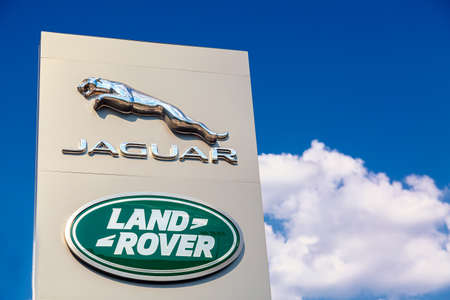 Moscow, Russia - August, 2021: Jaguar and Land Rover logo sign against blue sky. Jaguar and Land Rover are British multinational famous luxury car manufacturersのeditorial素材