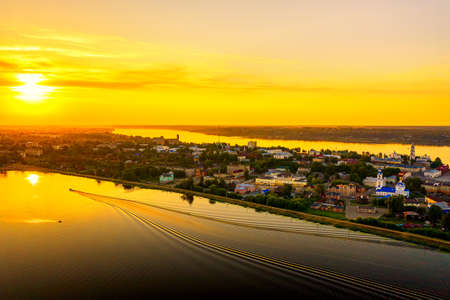 Aerial drone view of Kineshma ancient city with Volga river in Ivanovo region, Russia. Summer sunny day sunset.の写真素材