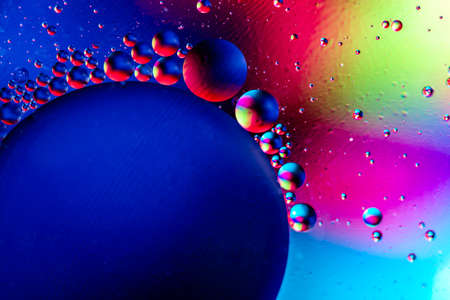 Abstract colorful background with oil on water surface. Oil drops in water abstract psychedelic....
