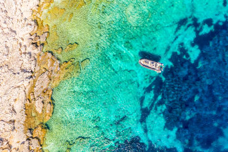 Aerial drone view of a boat with turquoise water. Ionian sea, Kefalonia Island, Greeceの写真素材