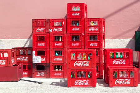 Corfu Island, Greece - September, 2021: Coca-cola red plastic boxes behind the cafe or restaurant outdoorsのeditorial素材
