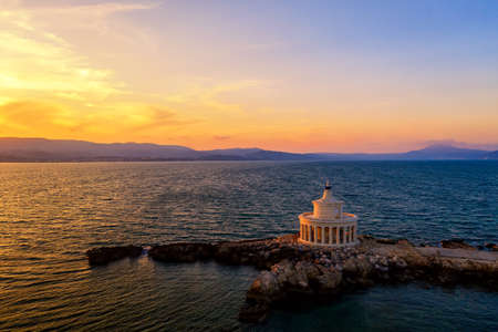 Landmark of Saint Theodore lighthouse in city of Argostoli at sunset, Kefalonia island, Greece.の写真素材