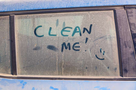 The inscription Clean me on a dirty car with a smile.の写真素材