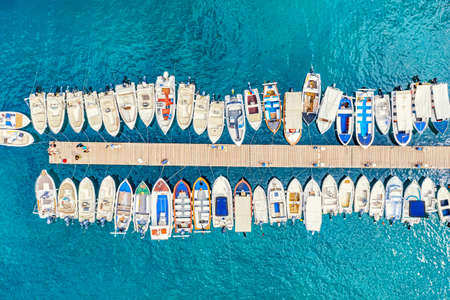 Aerial view of the boats and yachts on sea coast with transparent blue water. Paleokastritsa, Corfu Island, Greece.のeditorial素材