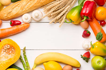 Vegetables, fruits assortment on white wooden background. Vegetarian healthy food concept. Food and grocery shopping.の写真素材