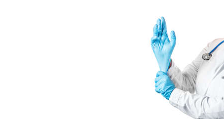 Nurse or doctor putting on medical protective rubber gloves isolated on white background. Free space for text.の写真素材