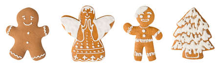 Christmas symbols. Smiling gingerbread men, angel and Christmas tree cookies isolated on white background isolated on white background.の写真素材
