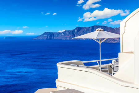 Luxury hotel in Oia, Santorini, Greece. Iconic image of vacation in Greece with sea and umbrella.の写真素材