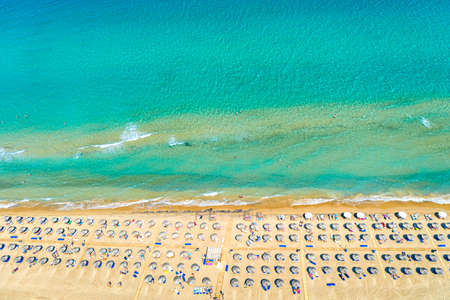 Top view aerial drone photo of Banana beach with beautiful turquoise water, sea waves and straw umbrellas. Vacation travel background. Ionian sea, Zakynthos Island, Greece.の写真素材
