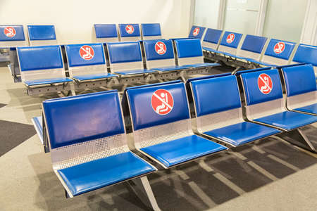 Social distancing COVID-19 concept. Passenger seats at Departure airport terminal during the corona virusの写真素材