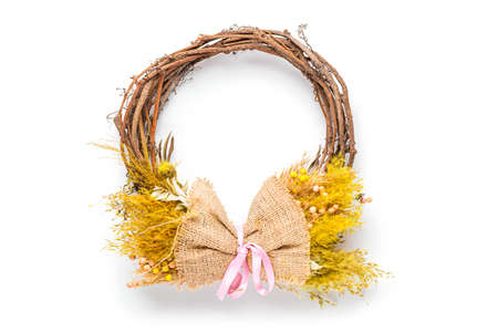 Decorative spring wreath with bright yellow flowers isolated on white background.の写真素材