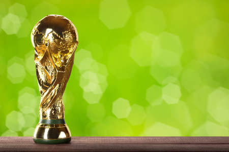 Moscow, Russia - April, 2022: FIFA World Cup Trophy against green background