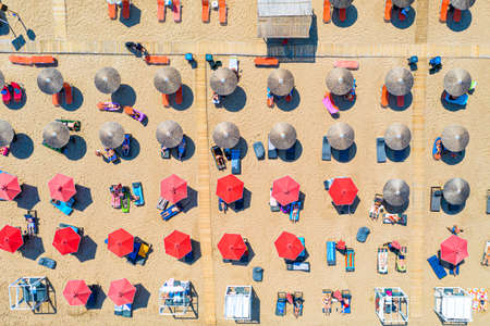 Top view aerial drone photo of Banana beach with red umbrellas. vacation travel background. Ionian sea, Zakynthos Island, Greece.の写真素材