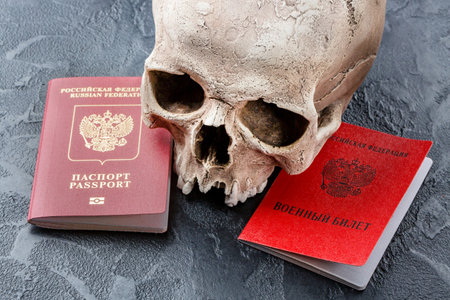 Russian documents passport, military ID and skull on black background. Death war concept. Translation: Russian Federation Military ID.の写真素材