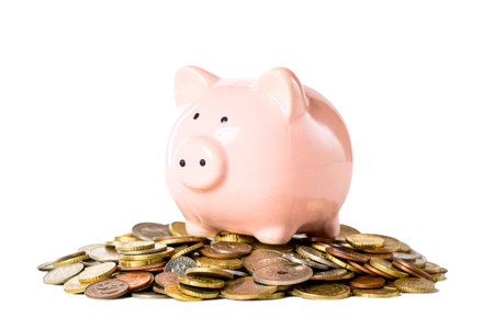 Pink piggybank on coins isolated on white background. business or finance conceptの写真素材
