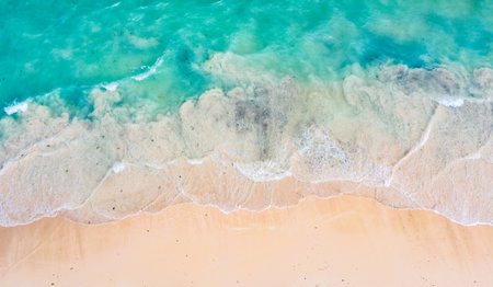 Top view aerial drone photo of ocean seashore with beautiful turquoise water and sea waves....