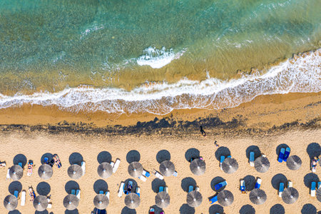 Vacation travel background. Ionian sea, Zakynthos Island, Greece. Top view aerial drone photo of Banana beach with beautiful turquoise water, sea waves and straw umbrellasの写真素材