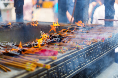Burning and smoking incense sticks at the Buddhist temple in Shanghai, Chinaの写真素材