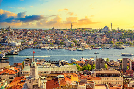 Touristic transport ships in Golden Horn bay of Istanbul and mosques with Sultanahmet Fatih district against colorful sunset. Istanbul, Turkiye.の写真素材