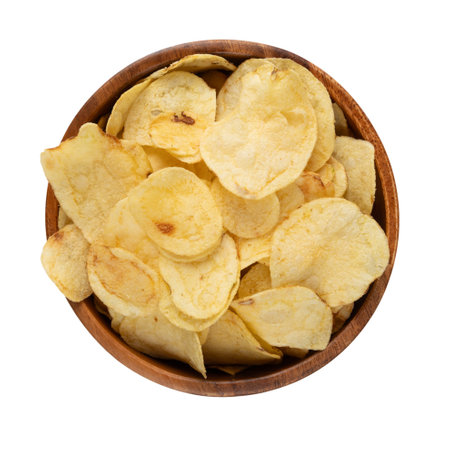 Close up view of potato chips in wooden bowl isolated on white background. Top viewの写真素材