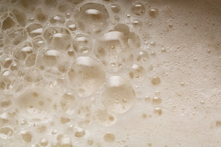 Close up of white foam with bubbles as a background.の写真素材