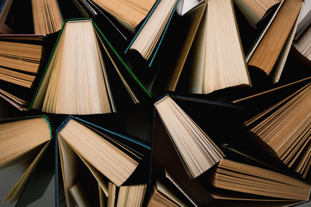 Education, library or school concept. Many opened books abstract image. Top view.