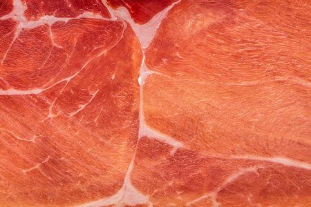 Spanish jamon or Italian prosciutto crudo ham close up. Meat ham macro food backgroundの写真素材