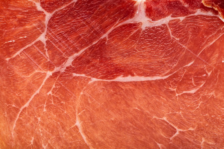 Spanish jamon or Italian prosciutto crudo ham close up. Meat ham macro food background.の写真素材