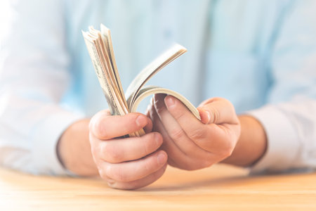Business, economy and finance concept. Big pile of money dollars in the hand. Close up of businessman counts 100 American dollar cash money in his hands.の写真素材